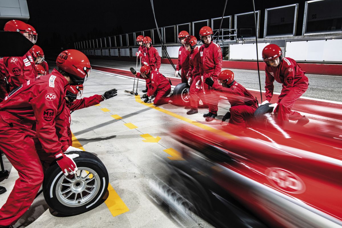 Roter Formel 1-Rennwagen, der zum Boxenstopp anhält
